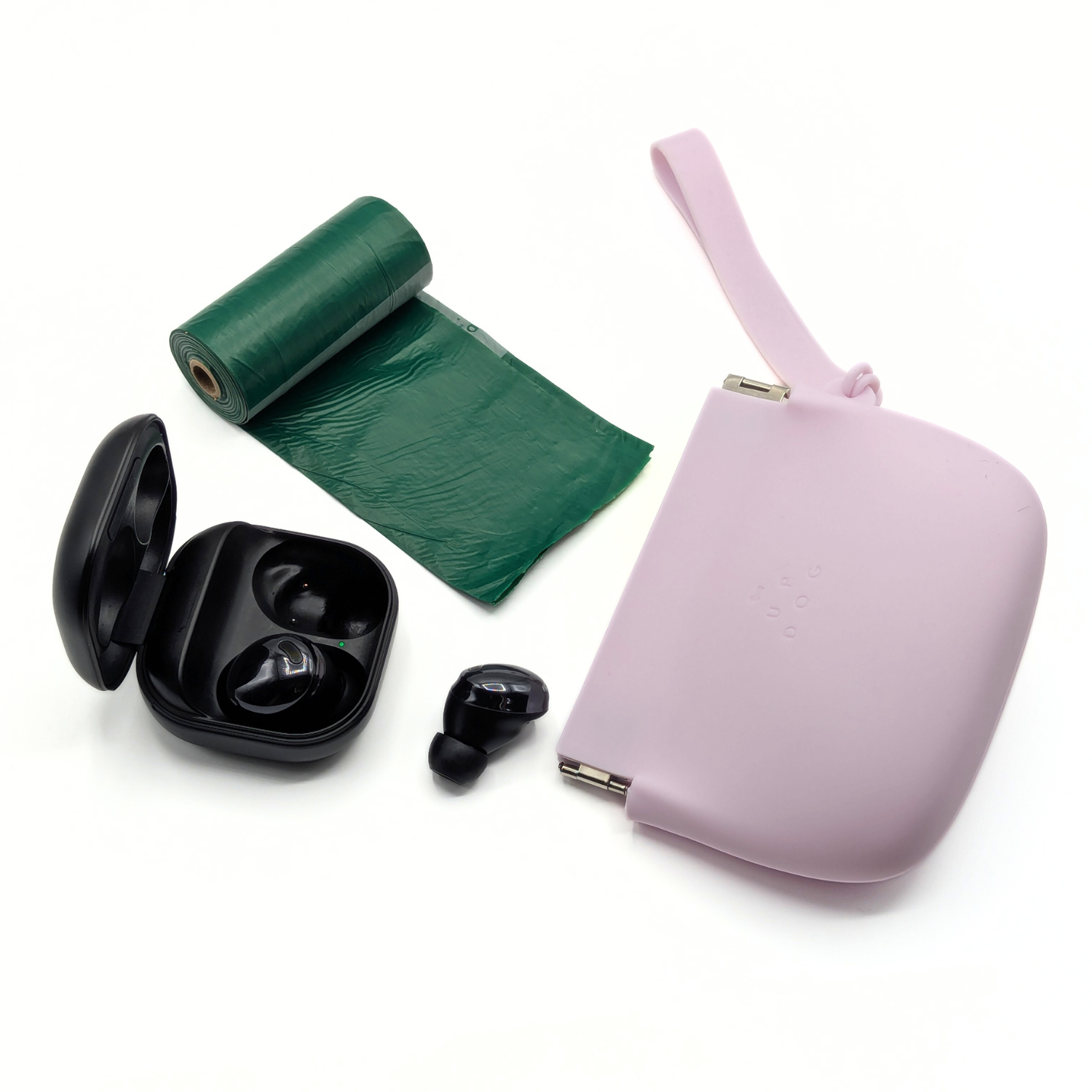 Mauve silicone treat pouch with wrist strap, plus waste bag roll and dispenser pieces.