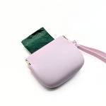 Mauve silicone treat pouch with wrist strap and visible waste bag roll accessory.