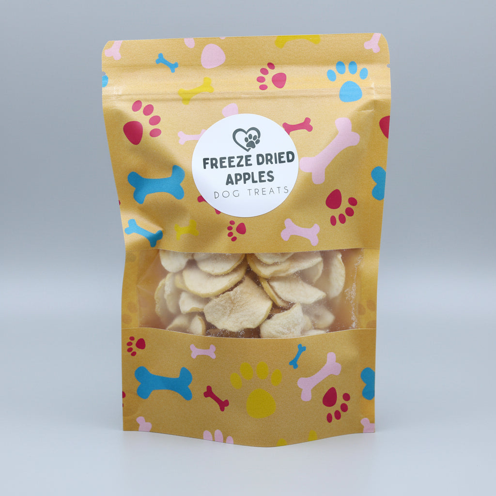Freeze-dried apple pet treats pouch with paw and bone print, filled with apple slices