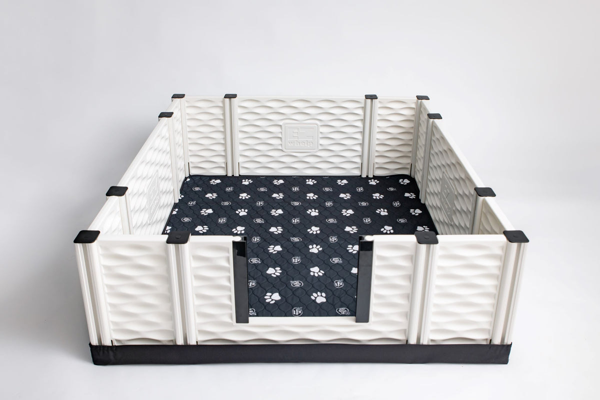 Black paw print pet mat fitted inside a white pet playpen base