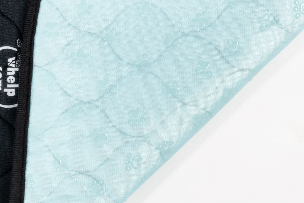 Light blue quilted pet mat backing with circular bubble texture and paw prints