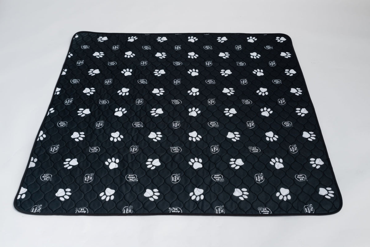 Black pet mat with white paw prints and quilted grip surface