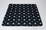 Black pet mat with white paw prints and quilted grip surface