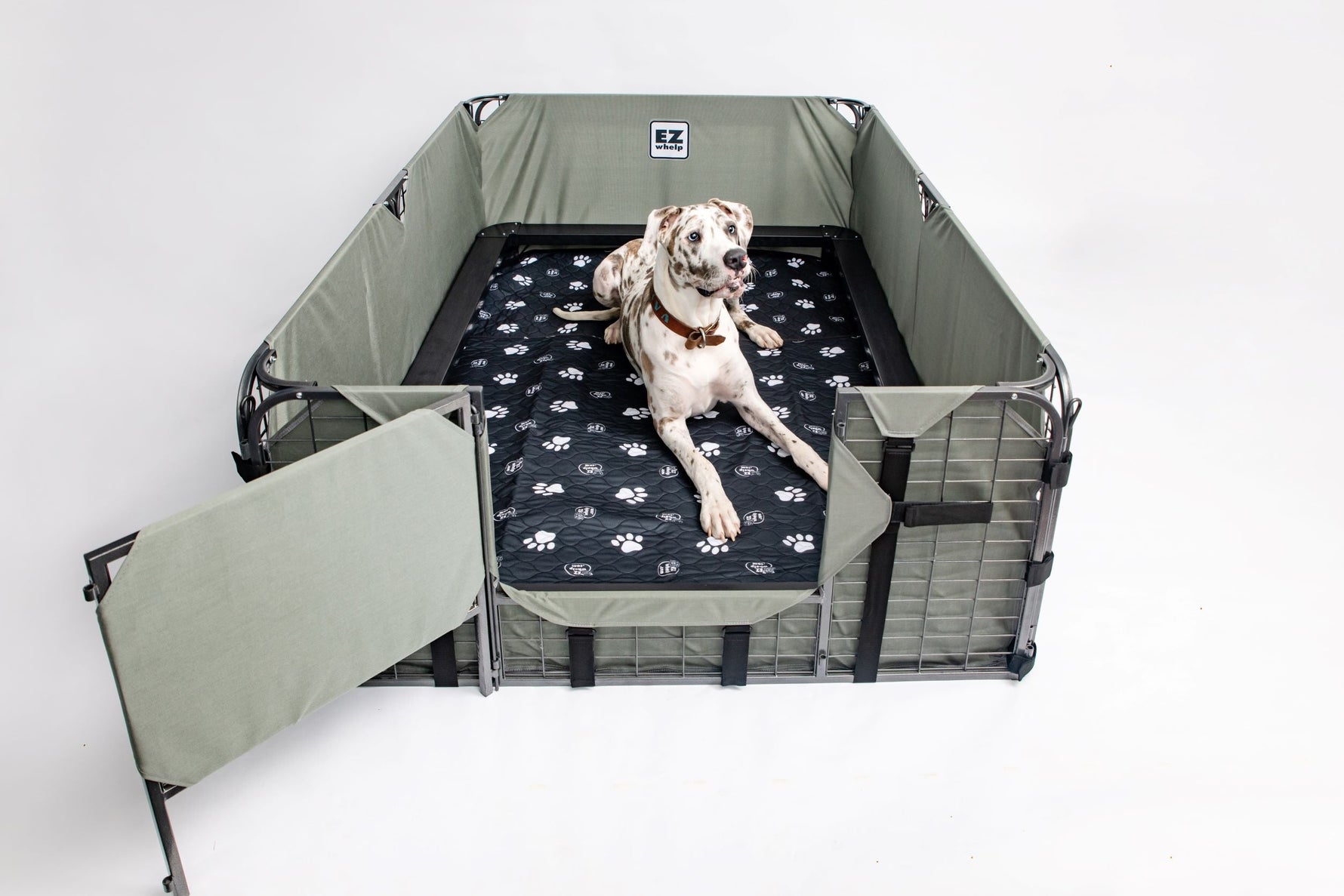 Black paw print pet mat inside a pet playpen, quilted surface