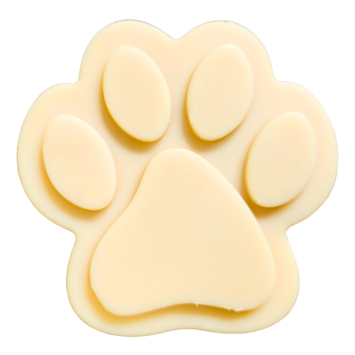 Paw-shaped goat milk soap bar with raised toe pads, pale yellow