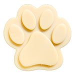 Paw-shaped goat milk soap bar with raised toe pads, pale yellow