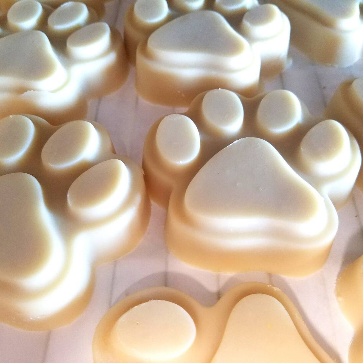 Stack of paw-print goat milk soap bars for dog shampoo