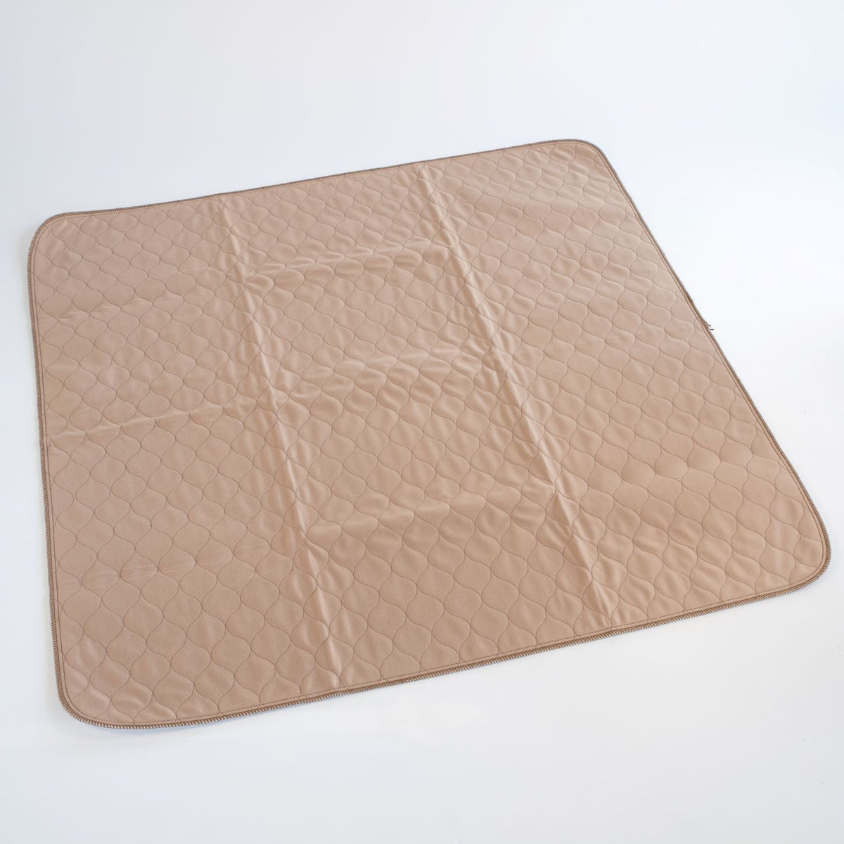 Tan square pet mat with quilted hex pattern and dark stitched border