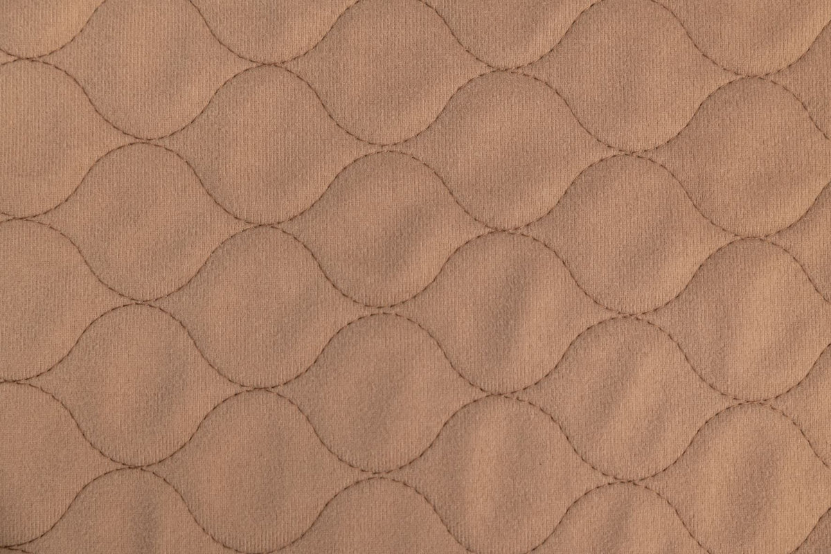 Tan pet mat fabric with quilted hex pattern texture