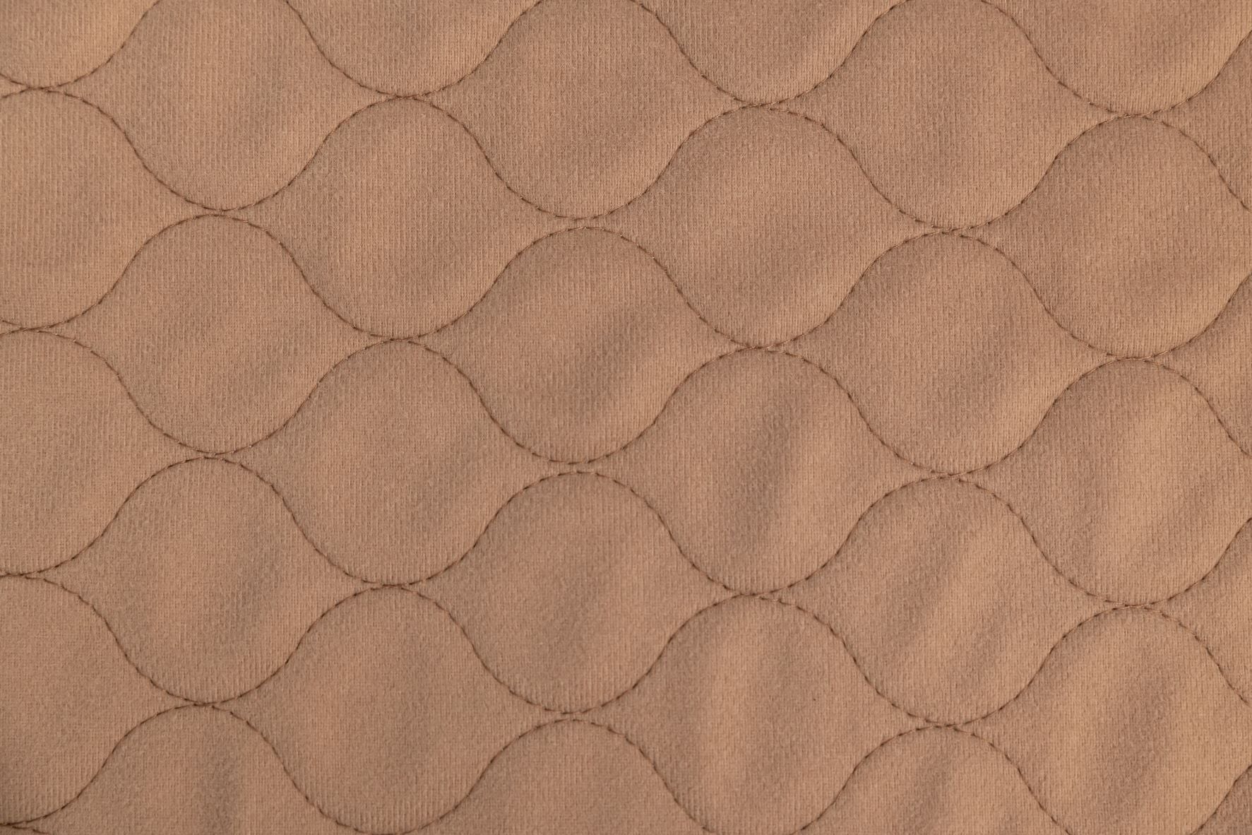 Tan pet mat fabric with quilted hex pattern texture