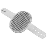 Gray silicone pet grooming brush with raised massage spikes and wrist holes