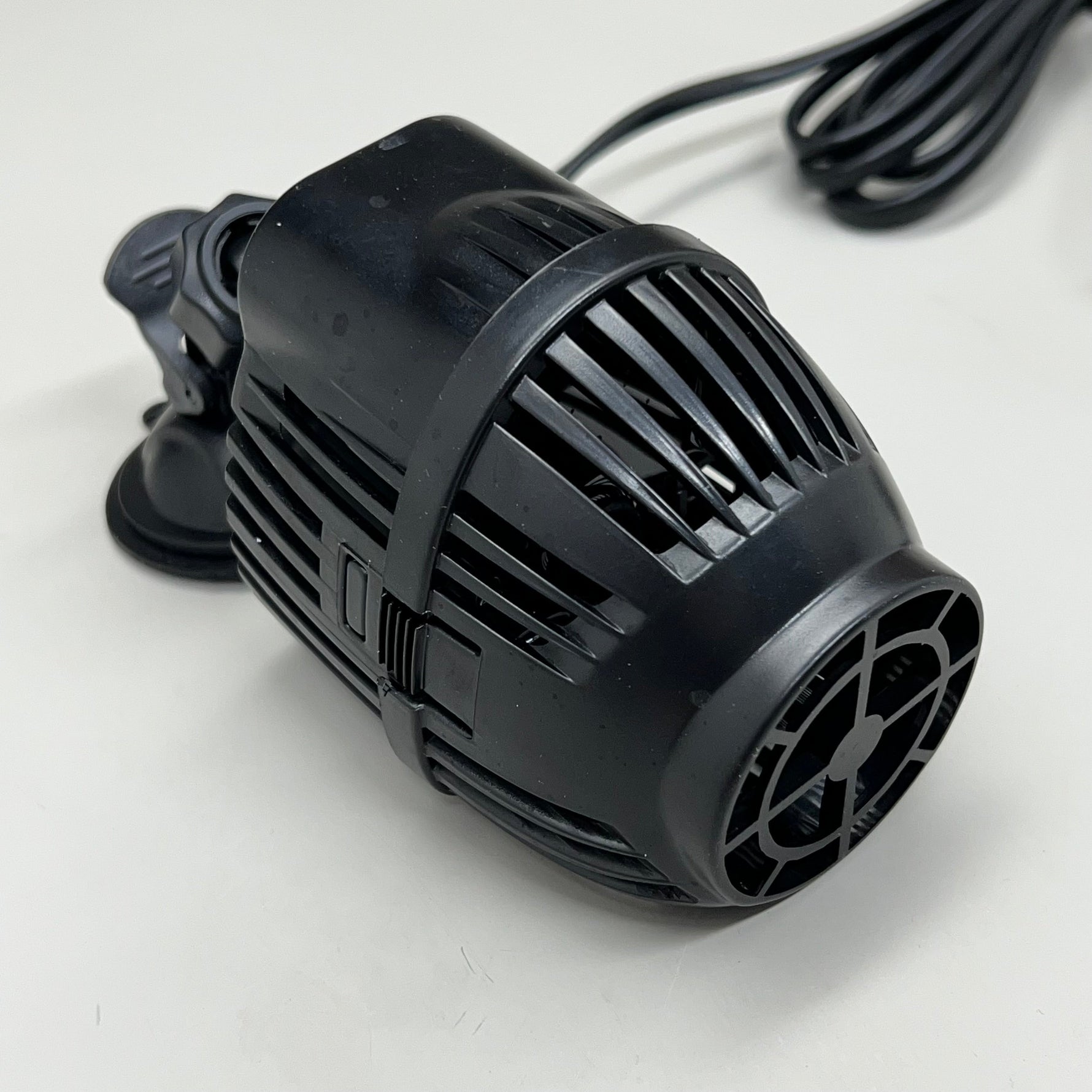 Black wave aquarium pump with intake grate and mounting clip attachment
