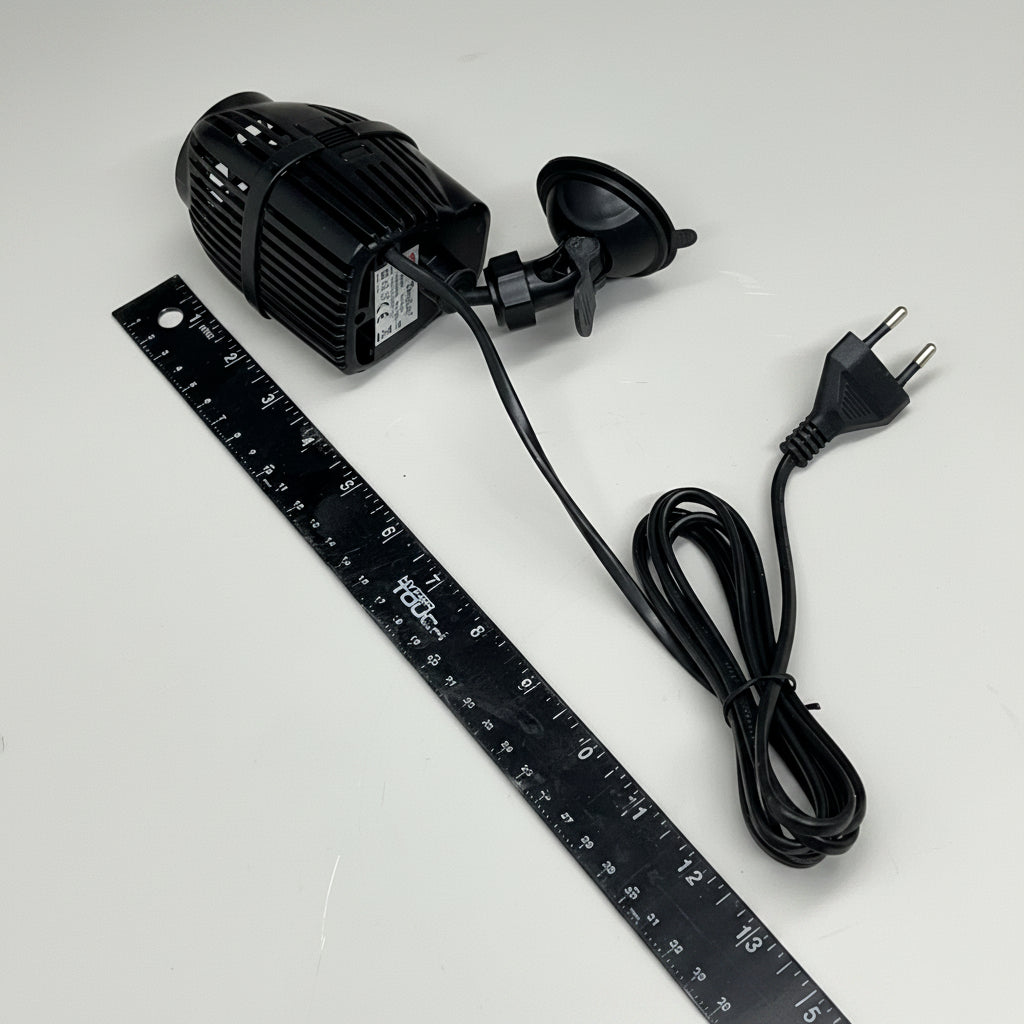 Wave aquarium pump with power cord and ruler for size comparison