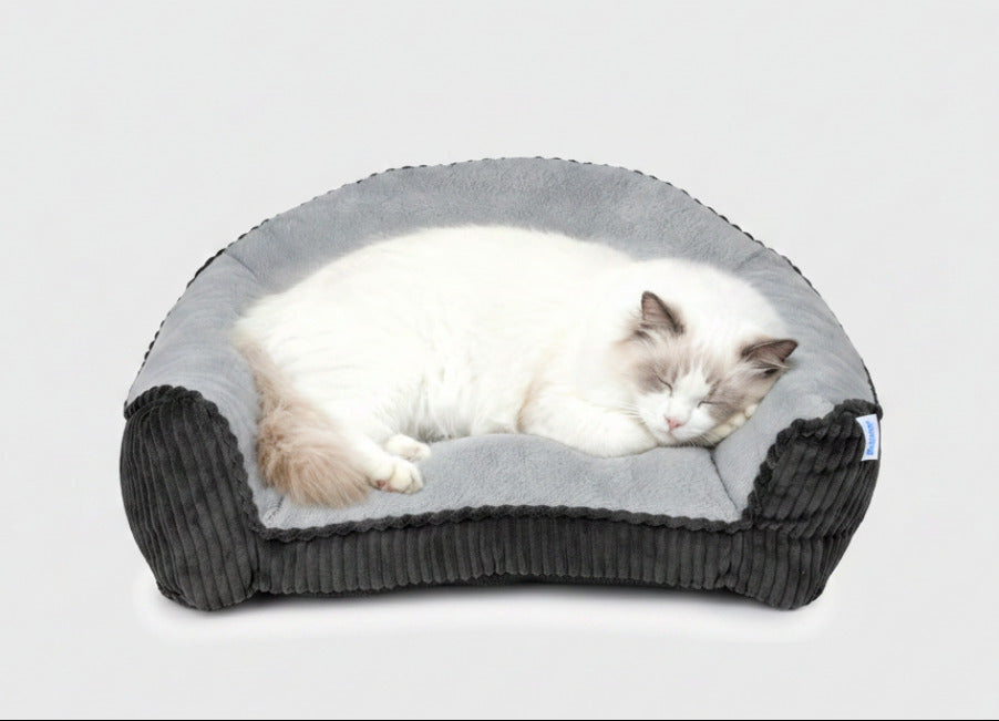 Grey faux fur pet sofa bed with raised bolstered rim and dark ribbed sides
