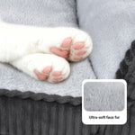 Grey faux fur pet bed with close-up paws resting on the soft inner cushion