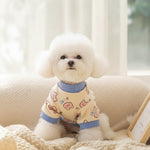 Cream fleece sweatshirt with blue ribbed collar and cuffs; cute dog print