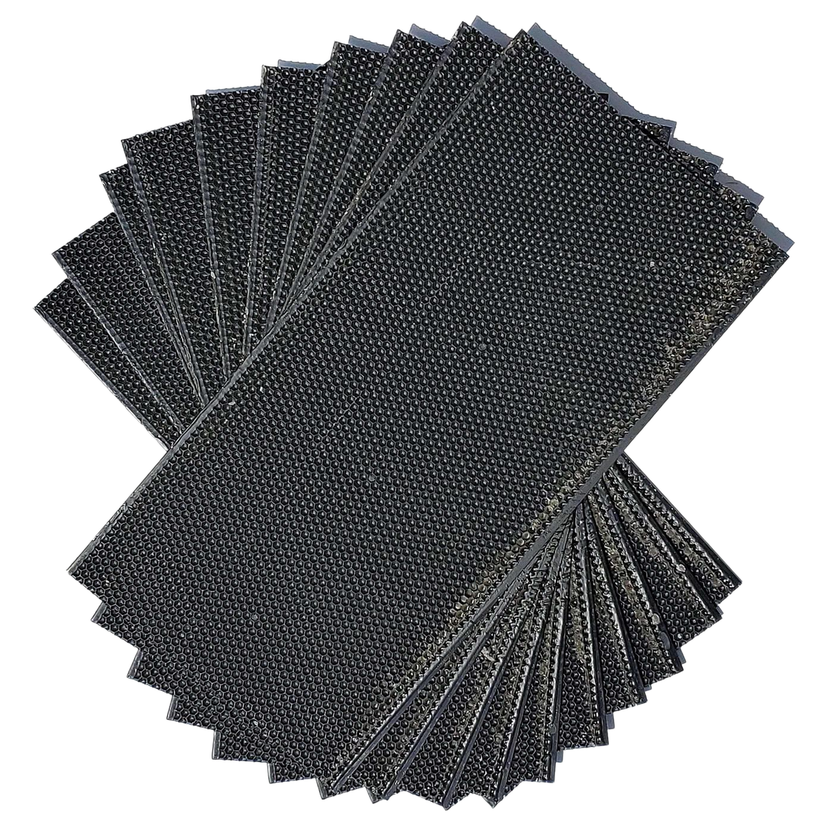 Dark plastic foundation sheets, hexagonal texture, stacked for beekeeping