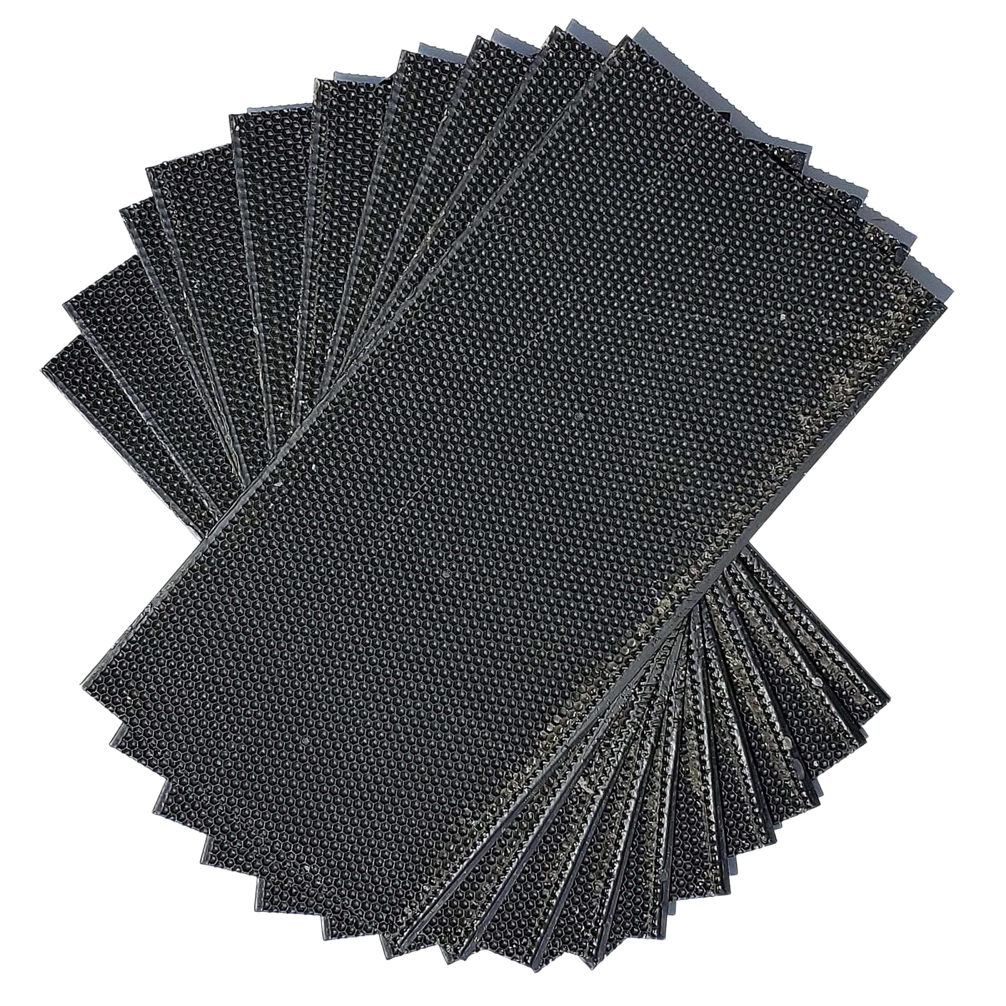 Dark plastic foundation sheets, hexagonal texture, stacked for beekeeping