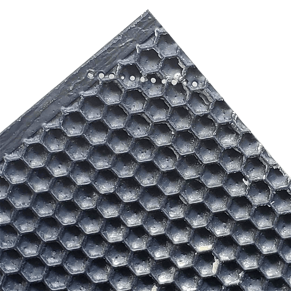 Close-up of dark plastic foundation with raised hexagon cells