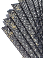 Stack of dark plastic foundation sheets with hexagonal cell pattern