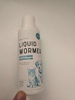 Liquid wormer bottle front view, white with teal 'LIQUID WORMER' label