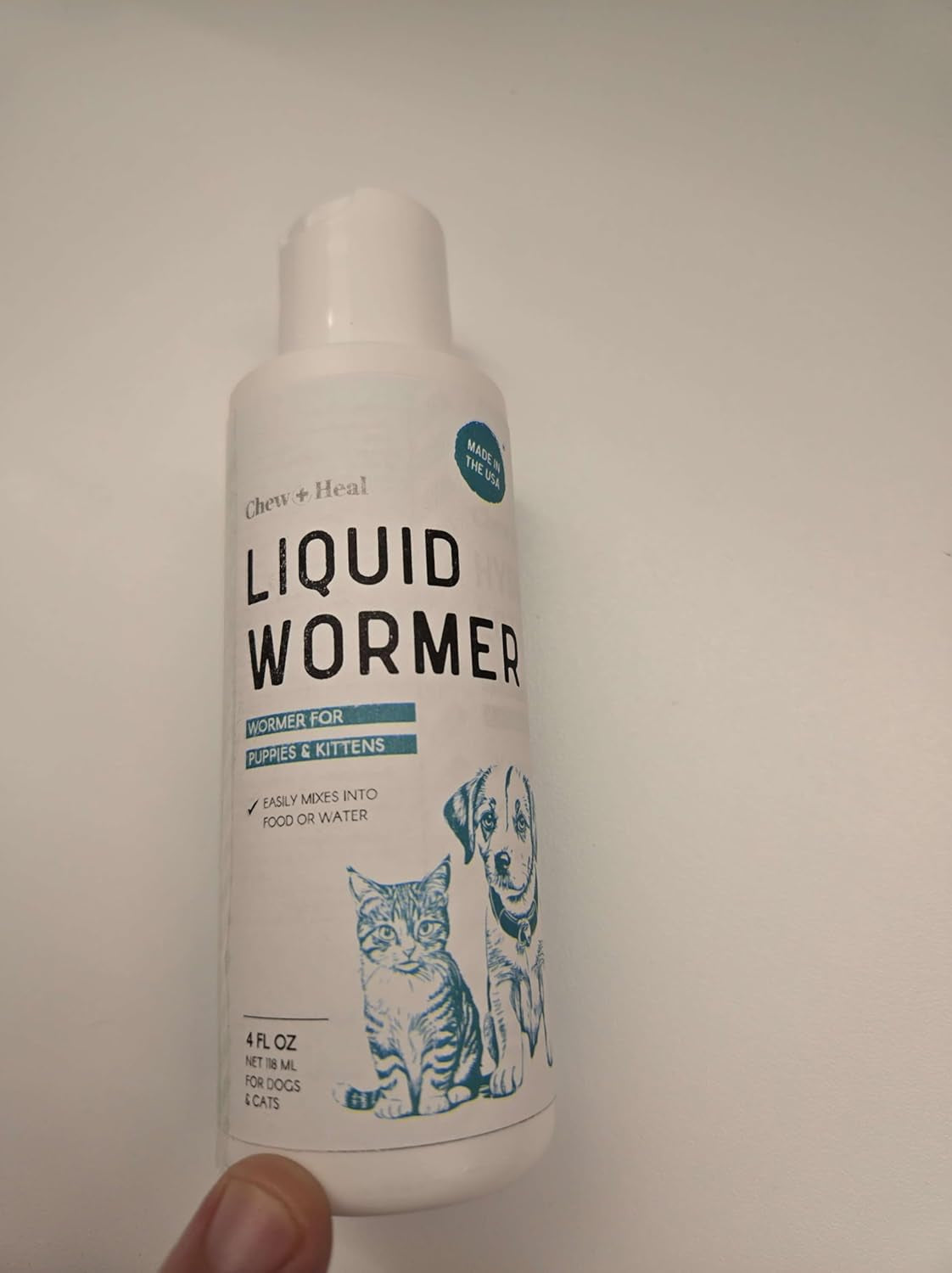 Liquid wormer bottle front view, white with teal 'LIQUID WORMER' label
