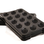 Black 15-slot hatch tray with ribbed circular egg wells, angled view