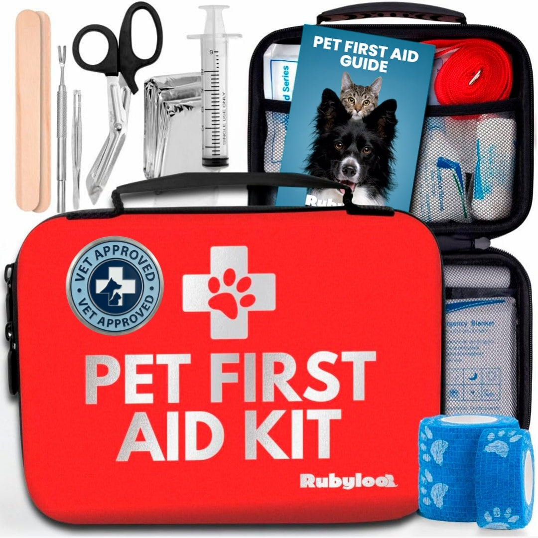 Red pet first aid kit case with paw icon, pet guide booklet, and medical tools
