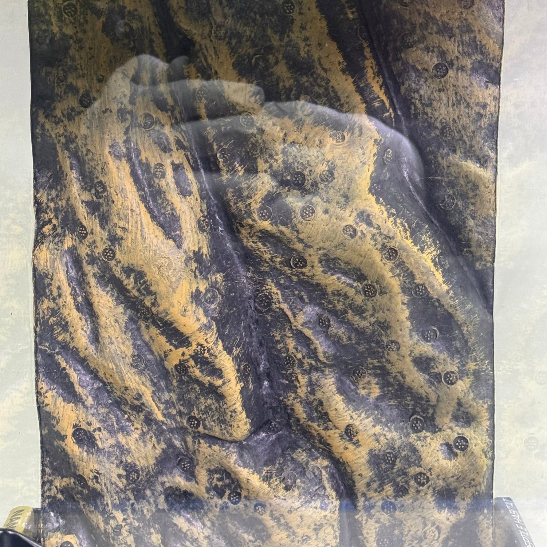 Natural terrarium package view of mottled dark substrate texture with yellow streaks