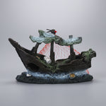 Black resin boat ornament with white net and gray rock base