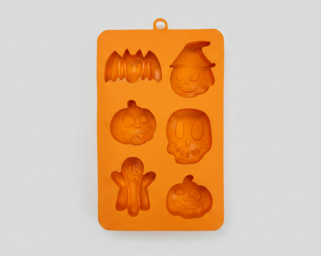 Orange silicone pet treat mold with Halloween figures: bat, witch, ghost, skull, and more.