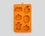 Orange silicone pet treat mold with Halloween figures: bat, witch, ghost, skull, and more.