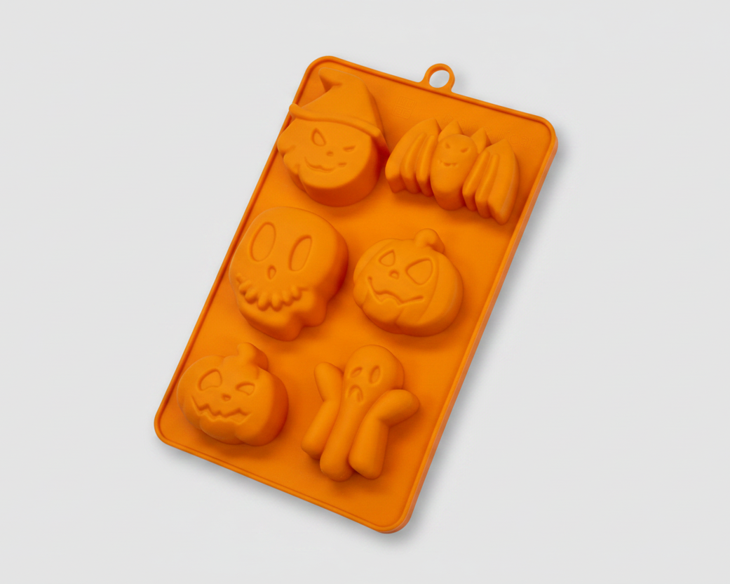 Orange silicone pet treat mold tray with dog bone and paw shapes