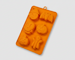 Orange silicone pet treat mold tray with dog bone and paw shapes