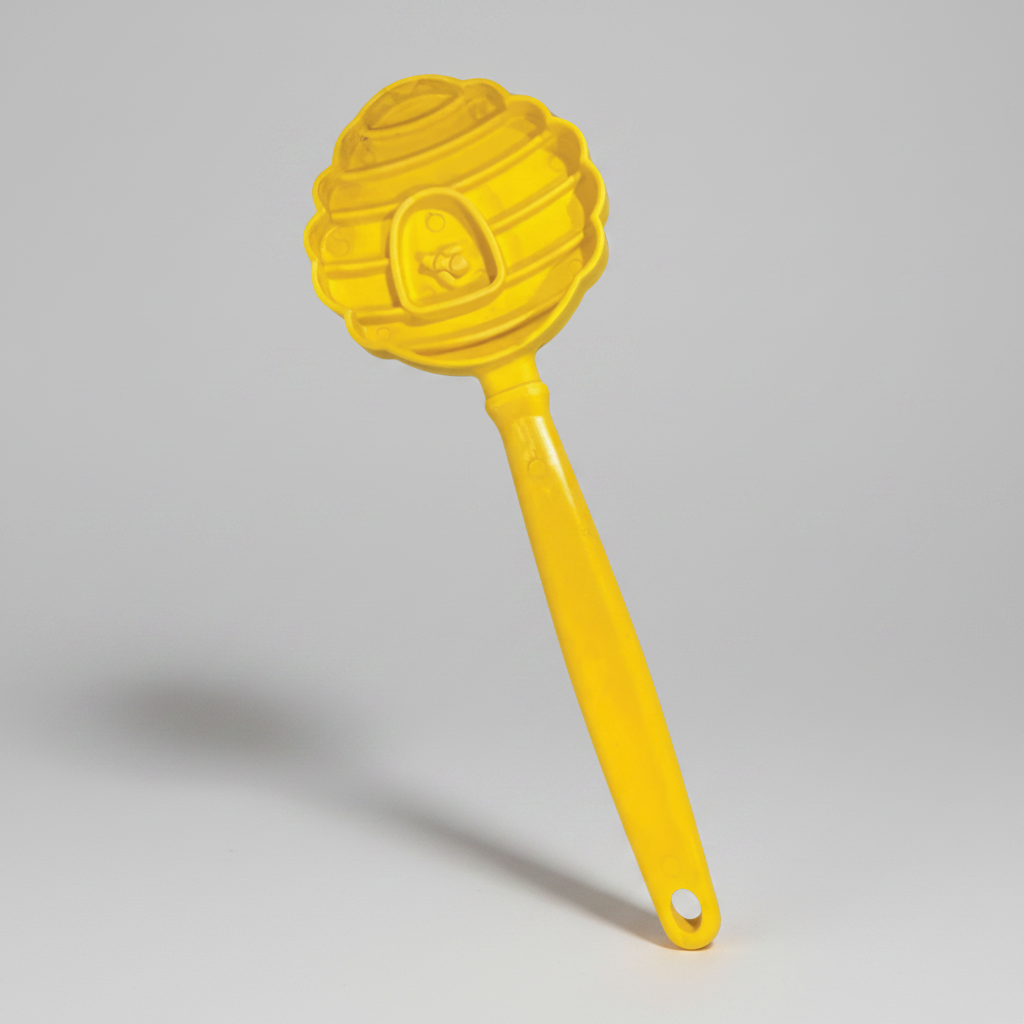 Yellow beehive-shaped dog lick toy with long handle.
