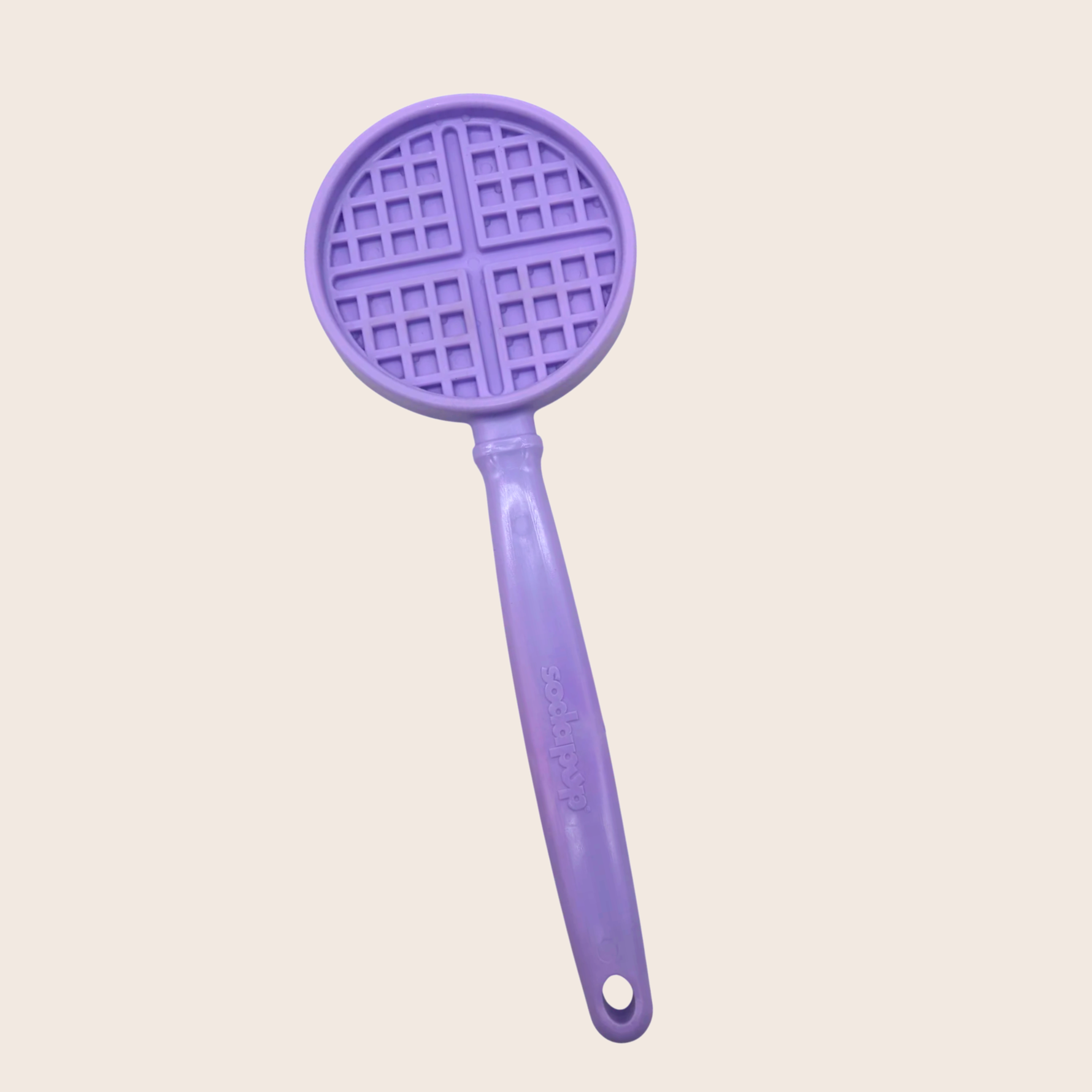 Purple waffle-grid shaped dog lick toy with long handle.