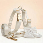 White satin pet collar and bowtie set with gold hardware, leash, and harness
