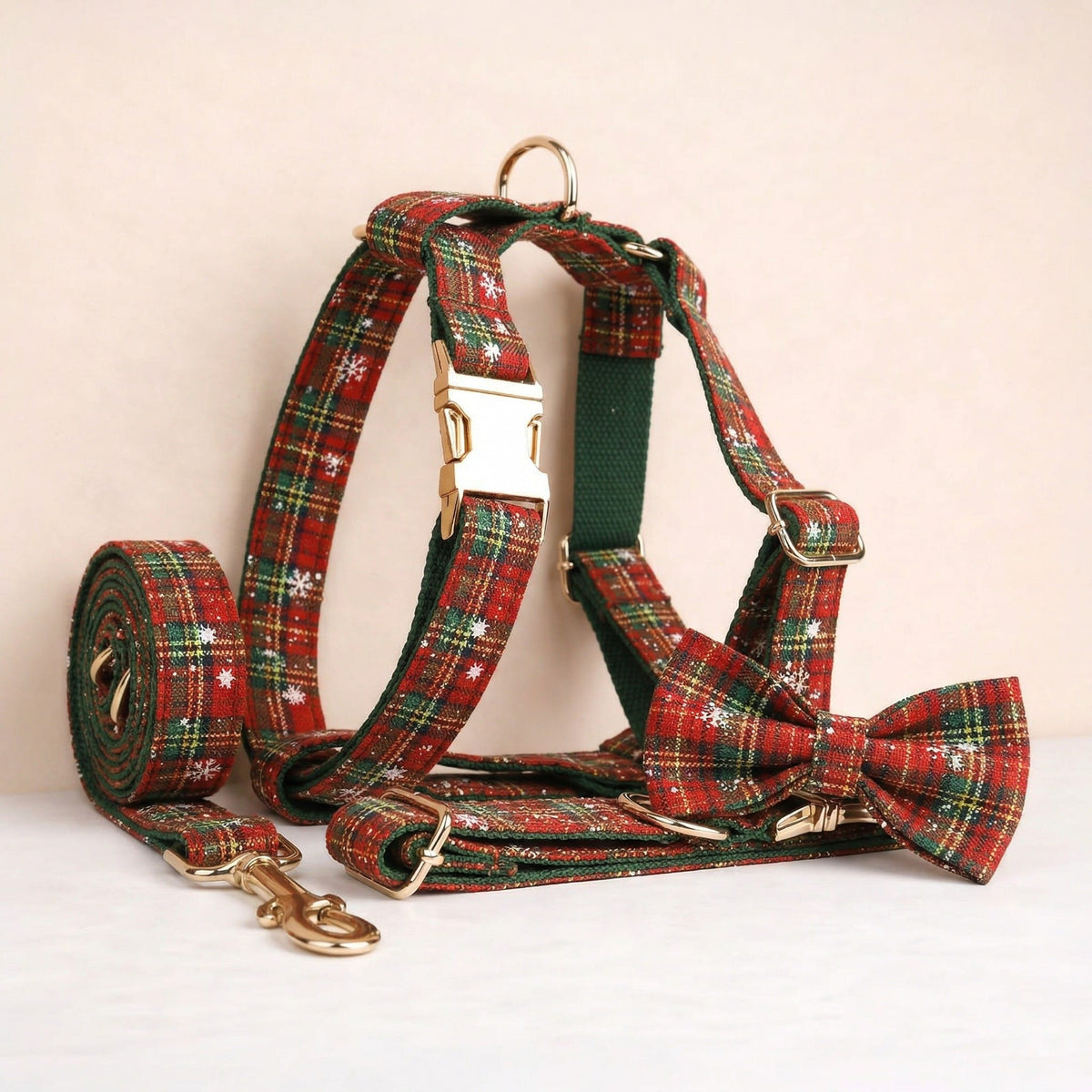 Red and green plaid dog harness set with matching bowtie, collar and leash