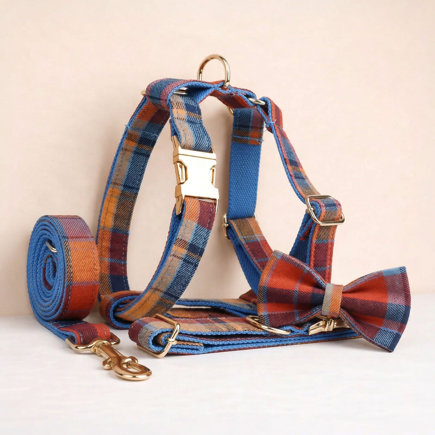 Plaid dog harness with collar and leash set, blue and rust tones, gold hardware