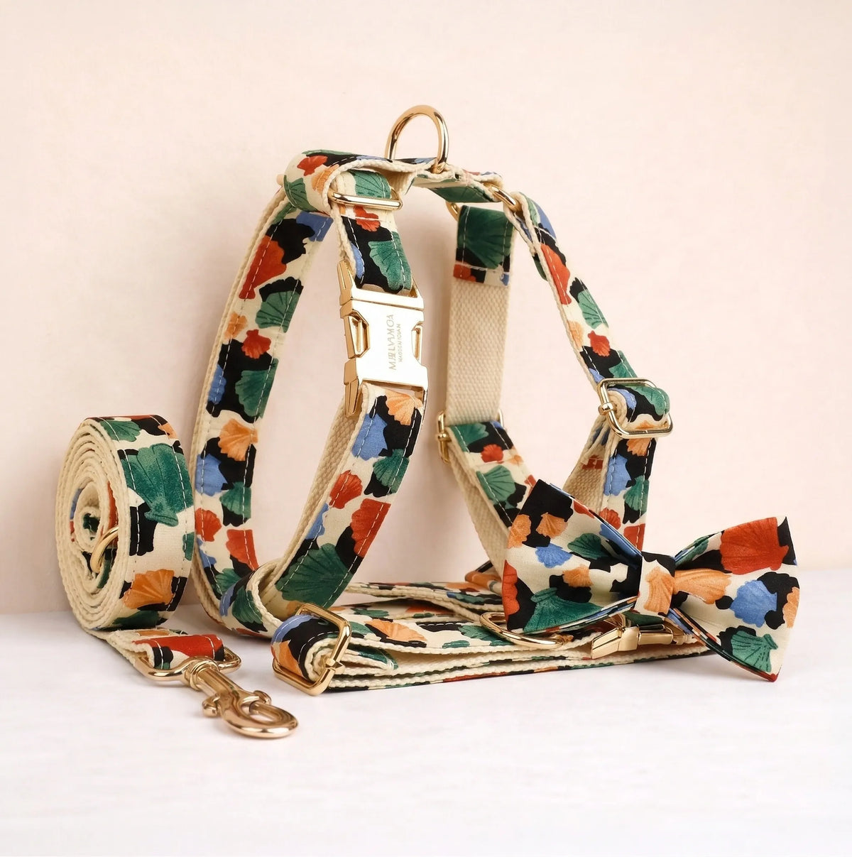 Dog harness and leash set with green, orange, and blue floral print straps