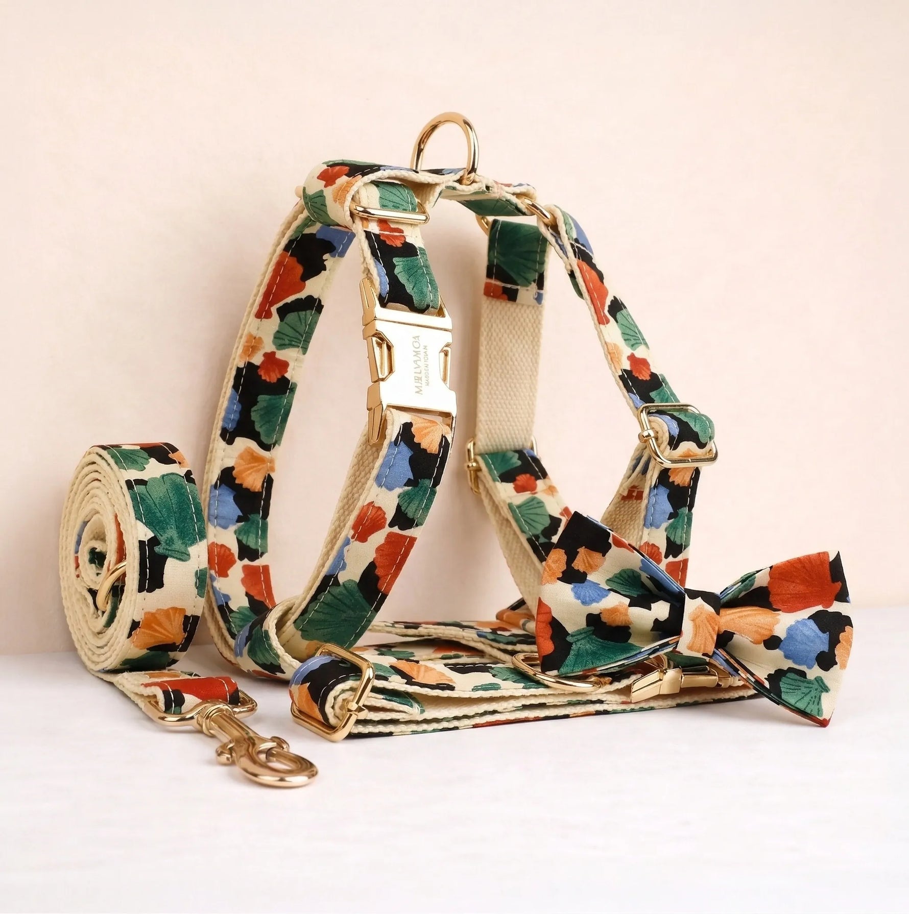 Dog harness and leash set with green, orange, and blue floral print straps