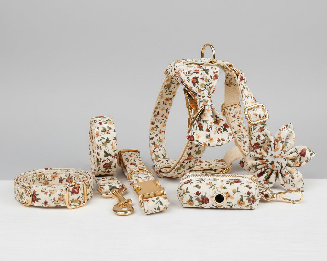 Dog accessory set with ivory floral collar, harness, leash, bowtie, flower, and poop bag holder