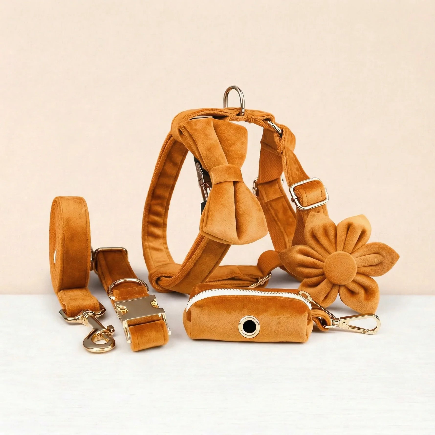 Orange velvet pet harness set with collar, leash, bowtie, flower, and poop bag holder