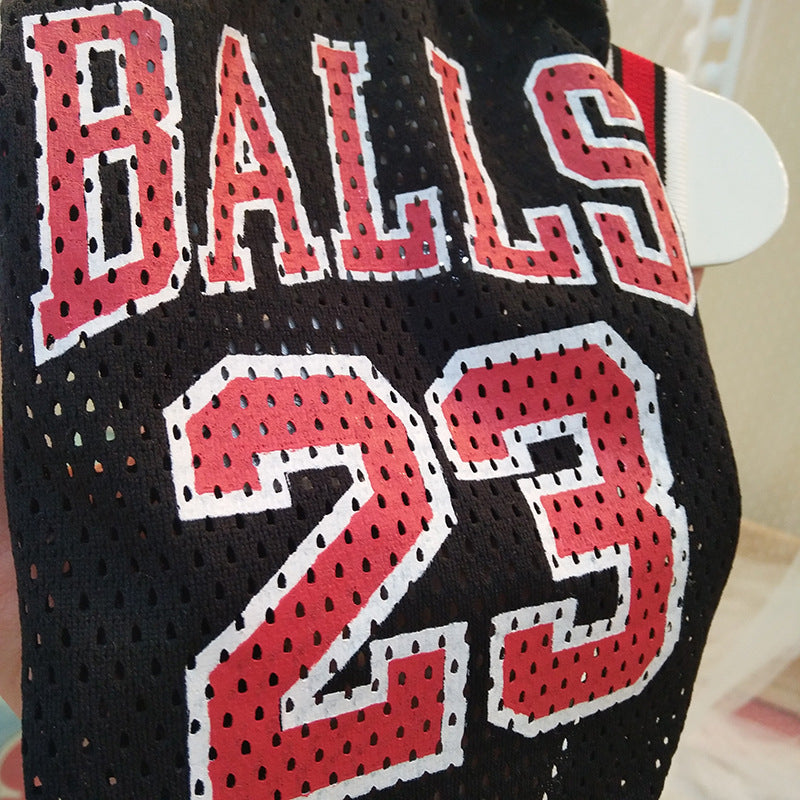 Close-up of black mesh basketball jersey front with red “BALLS 23” graphic