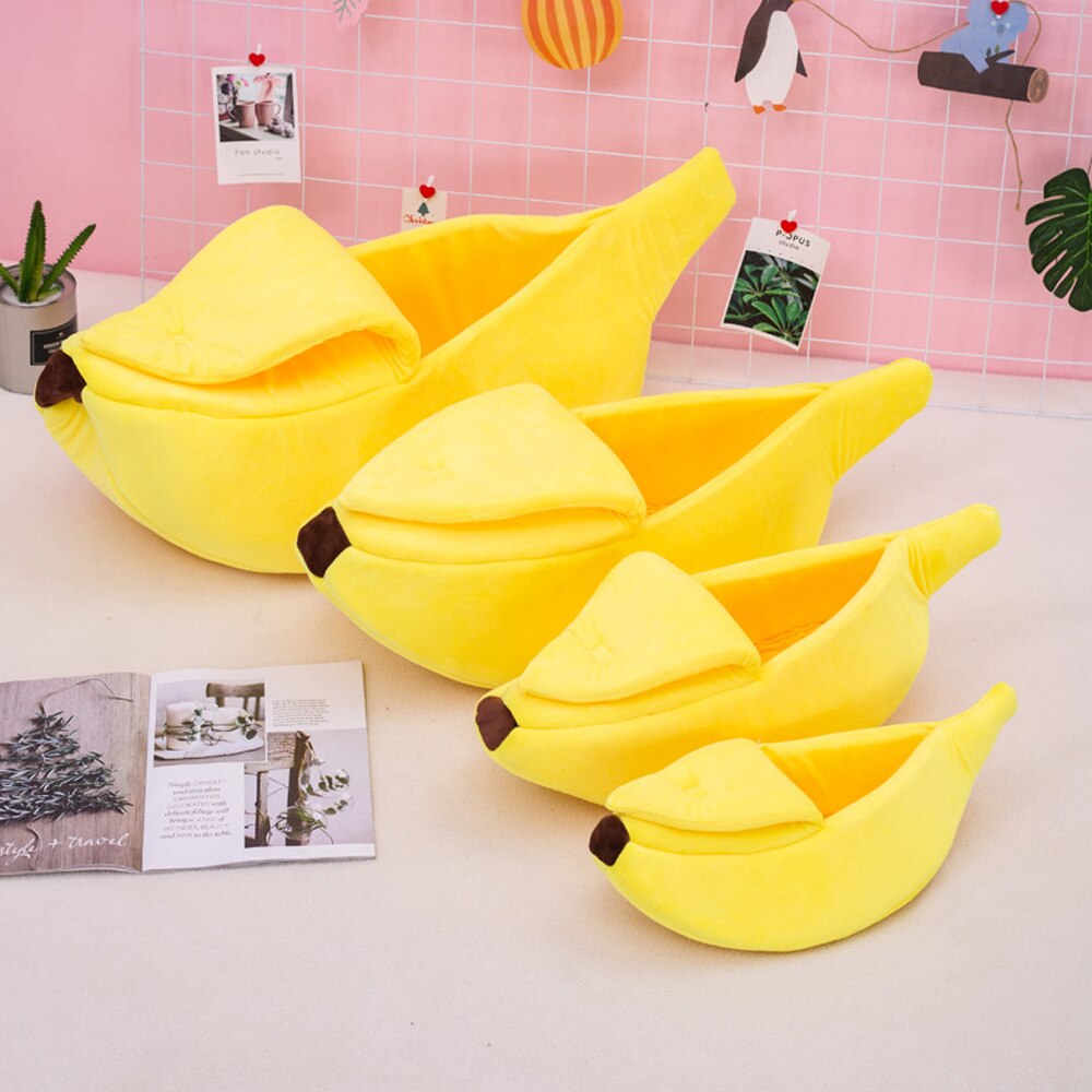 Yellow banana-shaped pet bed with plush bolster cushions, multiple beds shown