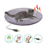 Electric heating pet bed mat, gray plush oval with USB cable, shown with cat on top