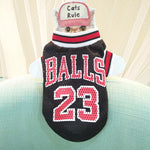 Black mesh basketball pet jersey with “BALLS 23” lettering and red-white-blue striped collar