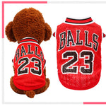 Pair of red and red/or dark basketball pet jerseys with “BALLS 23” number and striped collar