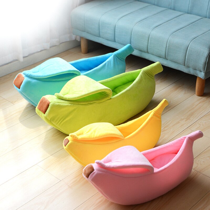 Blue banana-shaped pet bed with plush cushioned sides and rounded opening
