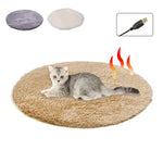 Electric heating pet bed mat, tan plush oval with USB cable, shown with cat on top